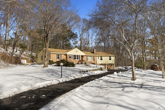 view of front of property featuring a garage and brick siding