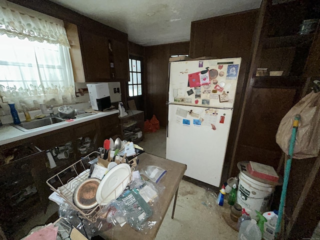 kitchen featuring white refrigerator and dark brown cabinets