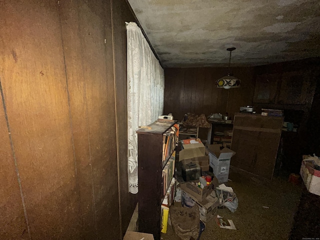 miscellaneous room featuring wood walls