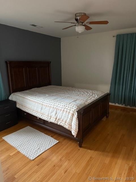 bedroom with ceiling fan and light hardwood / wood-style flooring