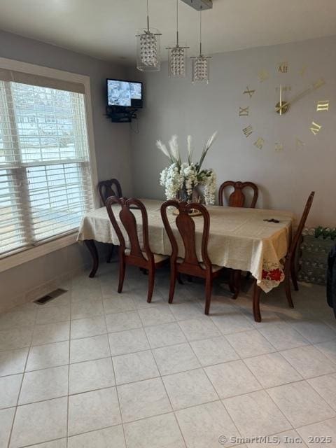 dining area featuring a healthy amount of sunlight and light tile patterned floors