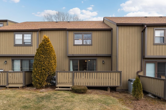 rear view of property featuring a lawn