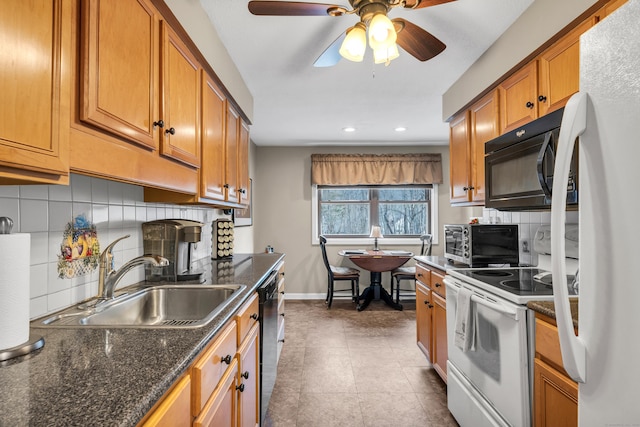 kitchen featuring sink, dark stone countertops, backsplash, ceiling fan, and black appliances