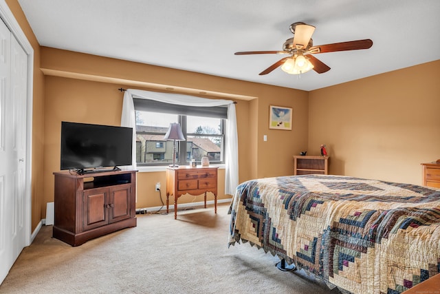 carpeted bedroom with a closet and ceiling fan