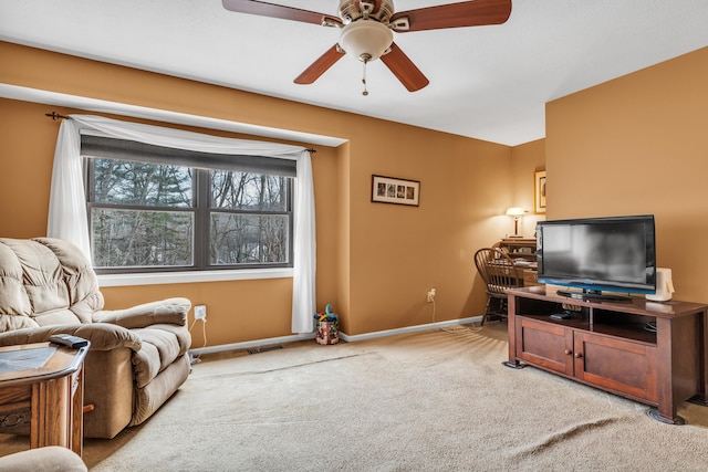 carpeted living room featuring ceiling fan