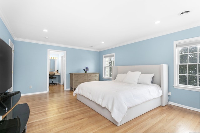 bedroom with light hardwood / wood-style floors, crown molding, and multiple windows