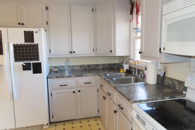 kitchen with white cabinetry, sink, and white appliances