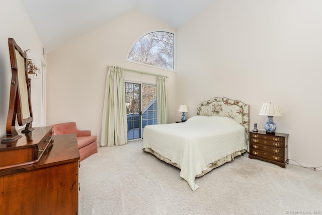 bedroom with carpet floors and high vaulted ceiling