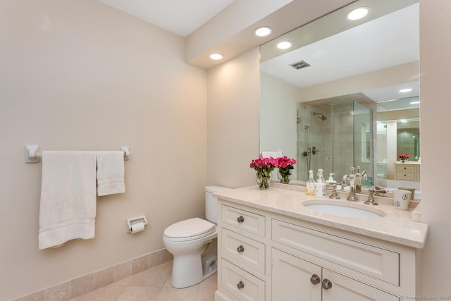 bathroom with tile patterned flooring, vanity, toilet, and walk in shower