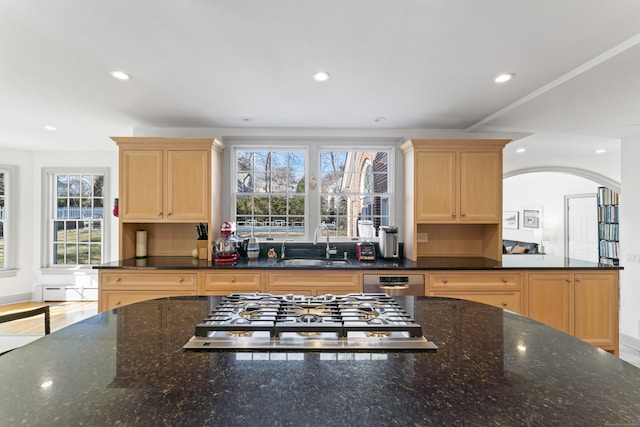 kitchen with recessed lighting, stainless steel gas cooktop, a sink, and light brown cabinetry