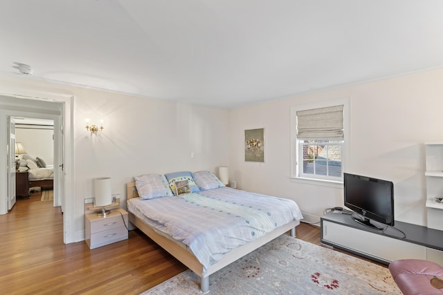 bedroom featuring wood finished floors and baseboards