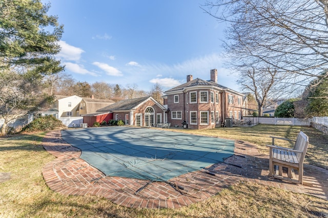 view of swimming pool with a fenced in pool, a lawn, fence, and a patio