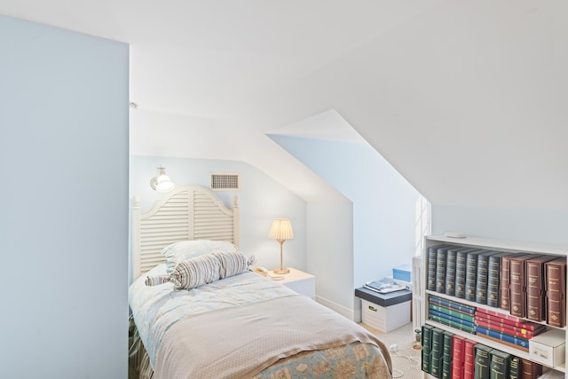 bedroom with lofted ceiling, baseboards, visible vents, and light colored carpet