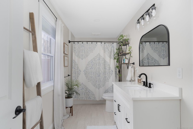 bathroom with vanity, hardwood / wood-style flooring, toilet, and a shower with shower curtain