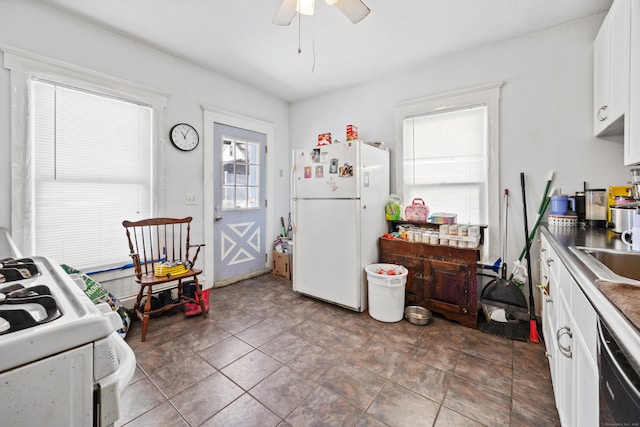 kitchen featuring sink, black dishwasher, white fridge, ceiling fan, and white cabinets