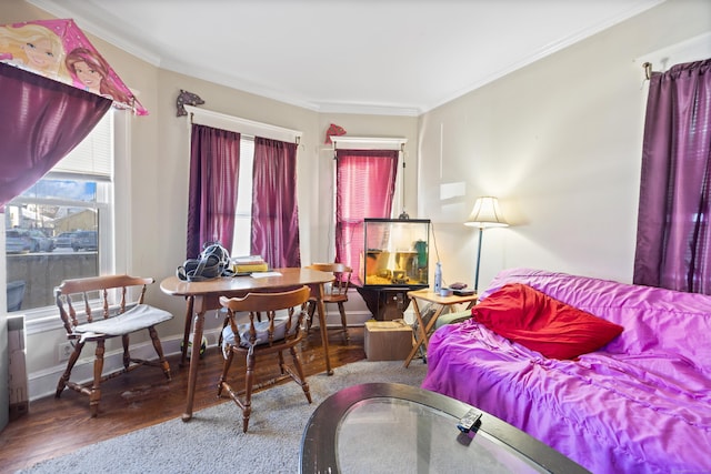 living room featuring wood-type flooring and crown molding