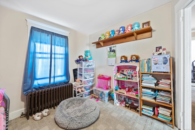 playroom featuring carpet floors and radiator heating unit