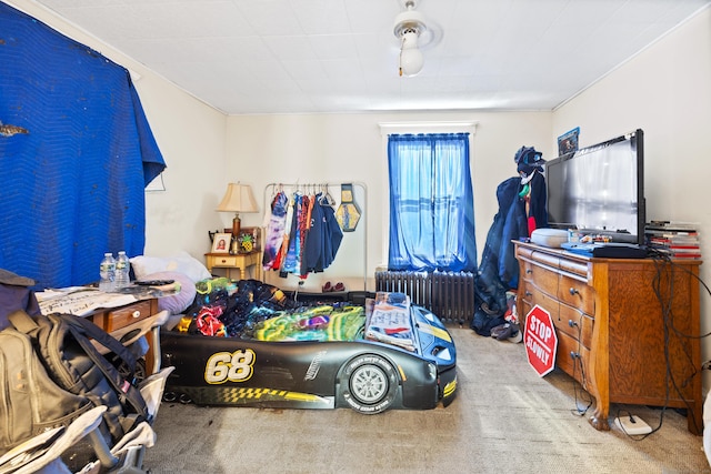 bedroom with carpet flooring and radiator