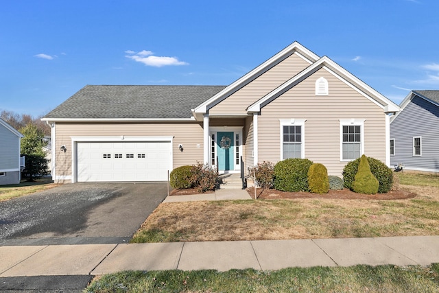 view of front of house featuring a garage and a front lawn