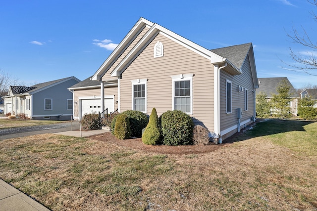 view of property exterior with a yard and a garage