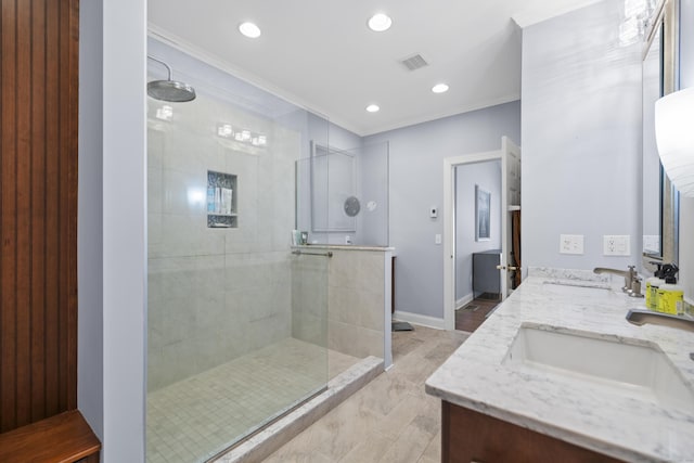 bathroom with vanity and a tile shower