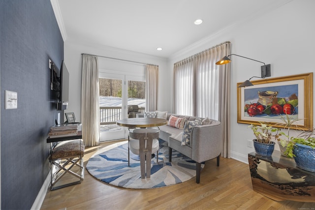 living room with crown molding and light hardwood / wood-style flooring