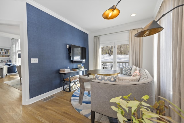 interior space featuring hardwood / wood-style flooring and ornamental molding