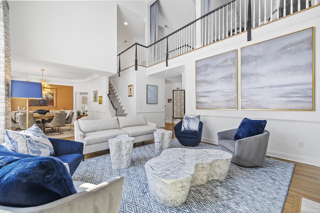 living room with a towering ceiling and hardwood / wood-style floors