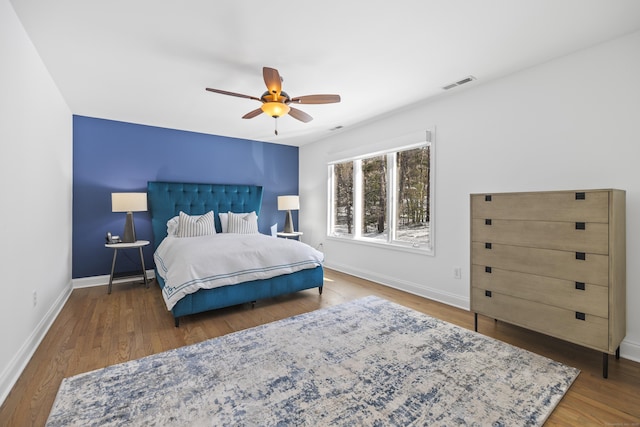 bedroom with ceiling fan and hardwood / wood-style floors