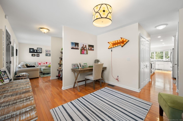 home office with light wood-type flooring