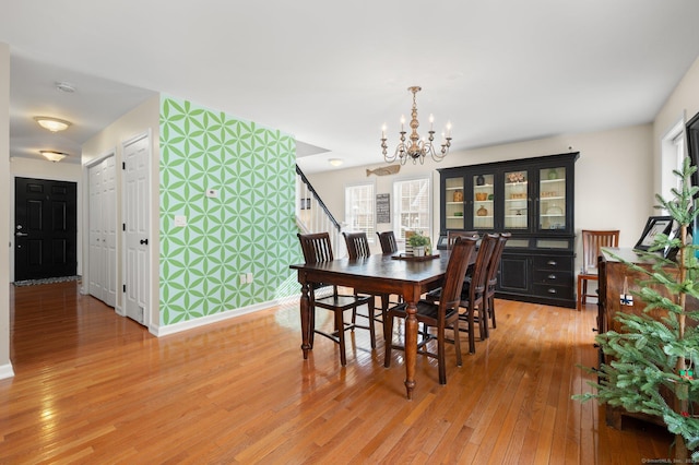 dining area featuring a notable chandelier and light wood-type flooring