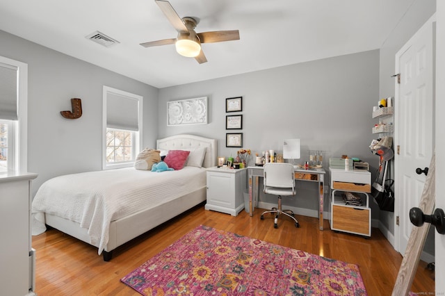 bedroom with ceiling fan and hardwood / wood-style floors