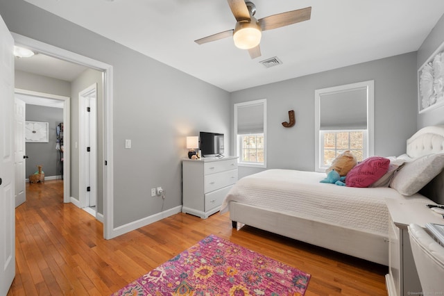 bedroom with ceiling fan and light hardwood / wood-style flooring