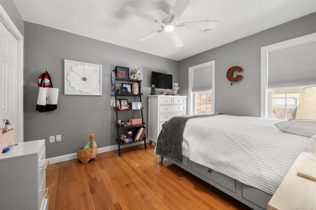 bedroom featuring light hardwood / wood-style floors, a closet, and ceiling fan