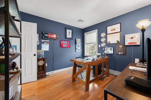 office featuring baseboard heating and light wood-type flooring