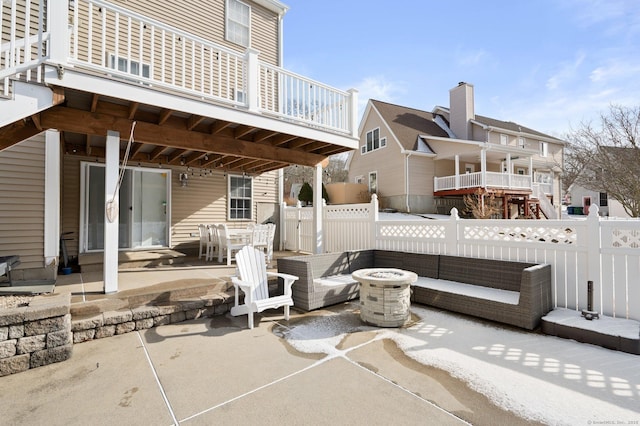 view of patio with an outdoor living space with a fire pit