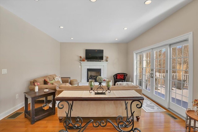 living room featuring light hardwood / wood-style flooring and french doors