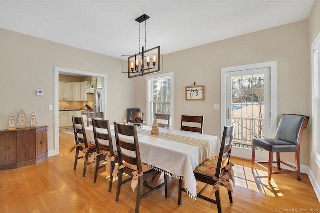 dining area with a chandelier and light wood-type flooring