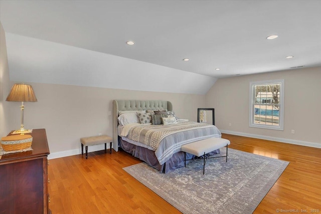 bedroom with lofted ceiling and hardwood / wood-style floors