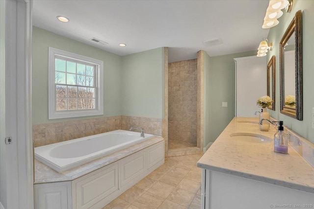 bathroom with independent shower and bath, vanity, and tile patterned flooring