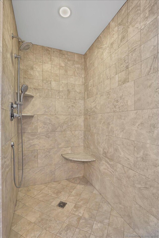 bathroom with tiled shower