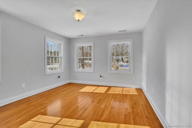 unfurnished room with wood-type flooring