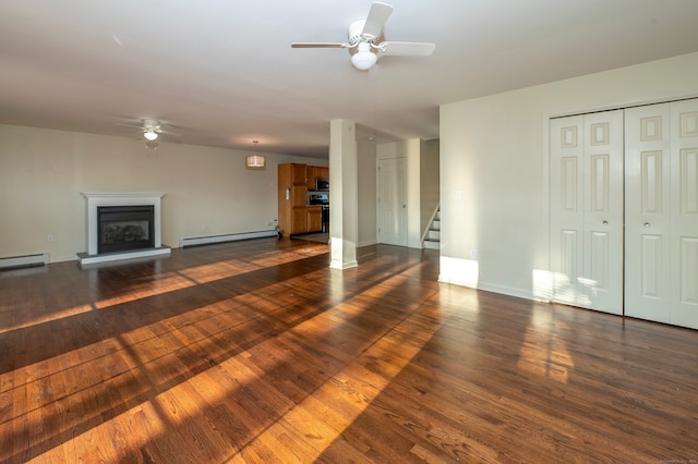 unfurnished living room with dark hardwood / wood-style floors, ceiling fan, and baseboard heating