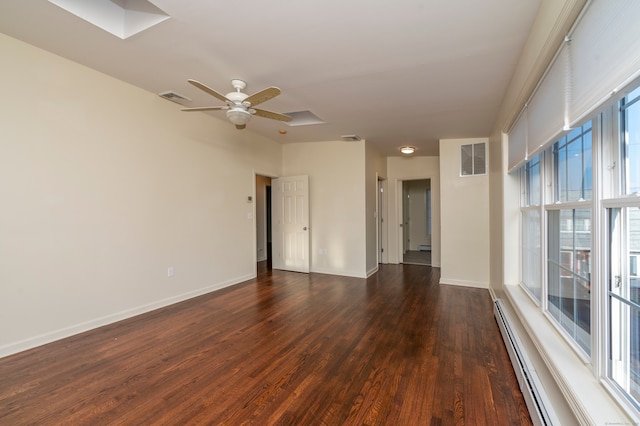 spare room featuring a baseboard heating unit, dark wood-type flooring, and ceiling fan