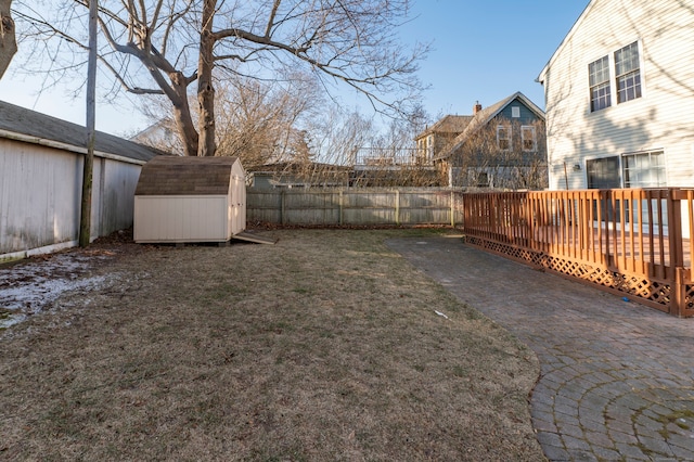 view of yard with a storage shed and a wooden deck