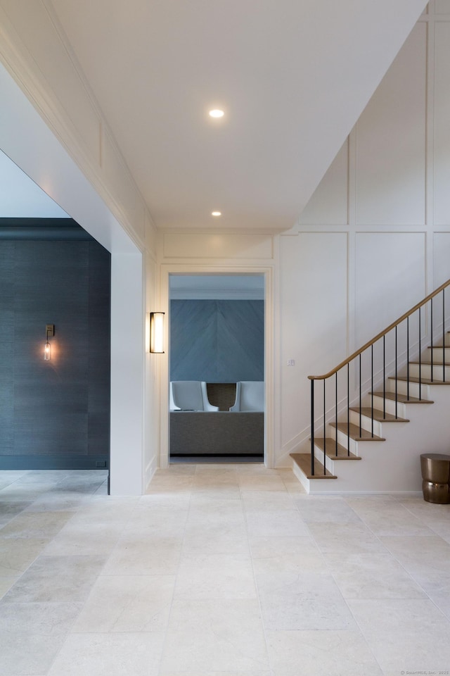 corridor featuring stairway, recessed lighting, tile patterned floors, and a decorative wall