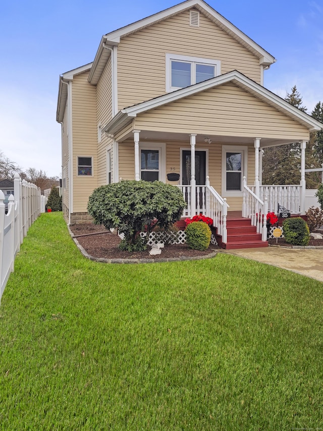 view of front of house featuring a front yard and covered porch