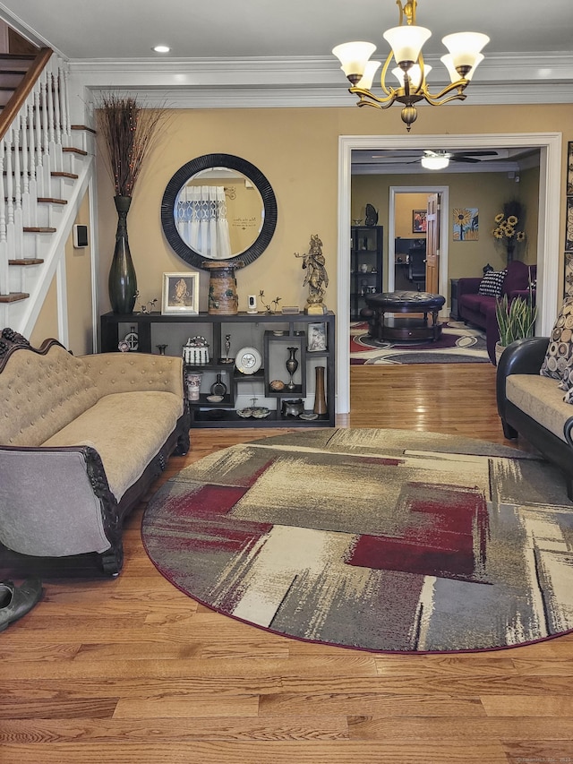 interior space featuring a notable chandelier, wood-type flooring, and ornamental molding