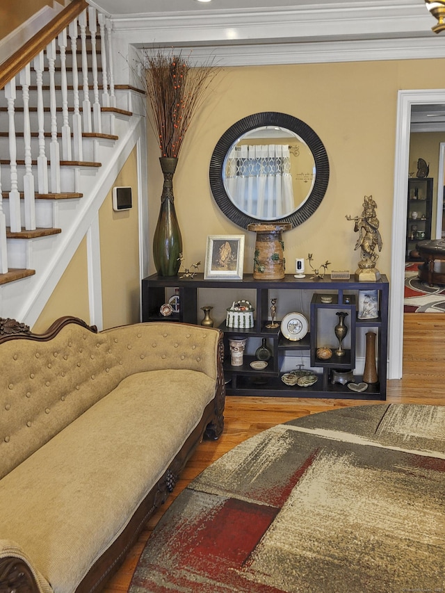 living area featuring ornamental molding and wood-type flooring