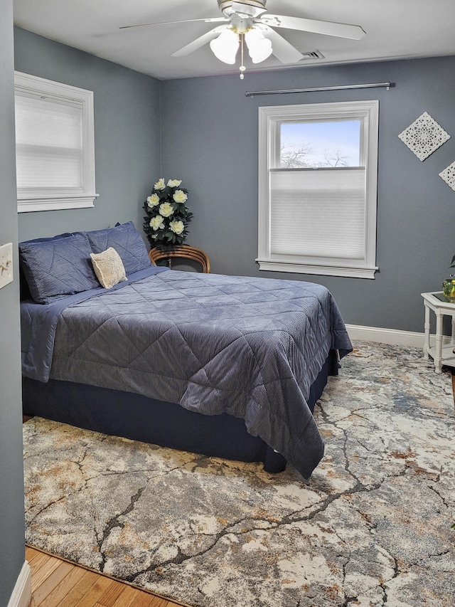 bedroom with wood-type flooring and ceiling fan